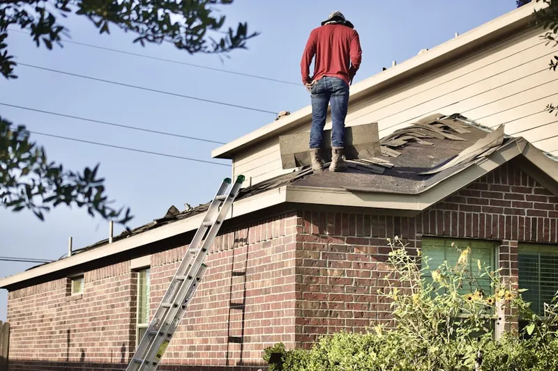 Professional roofer working on a residential roof in Near - North